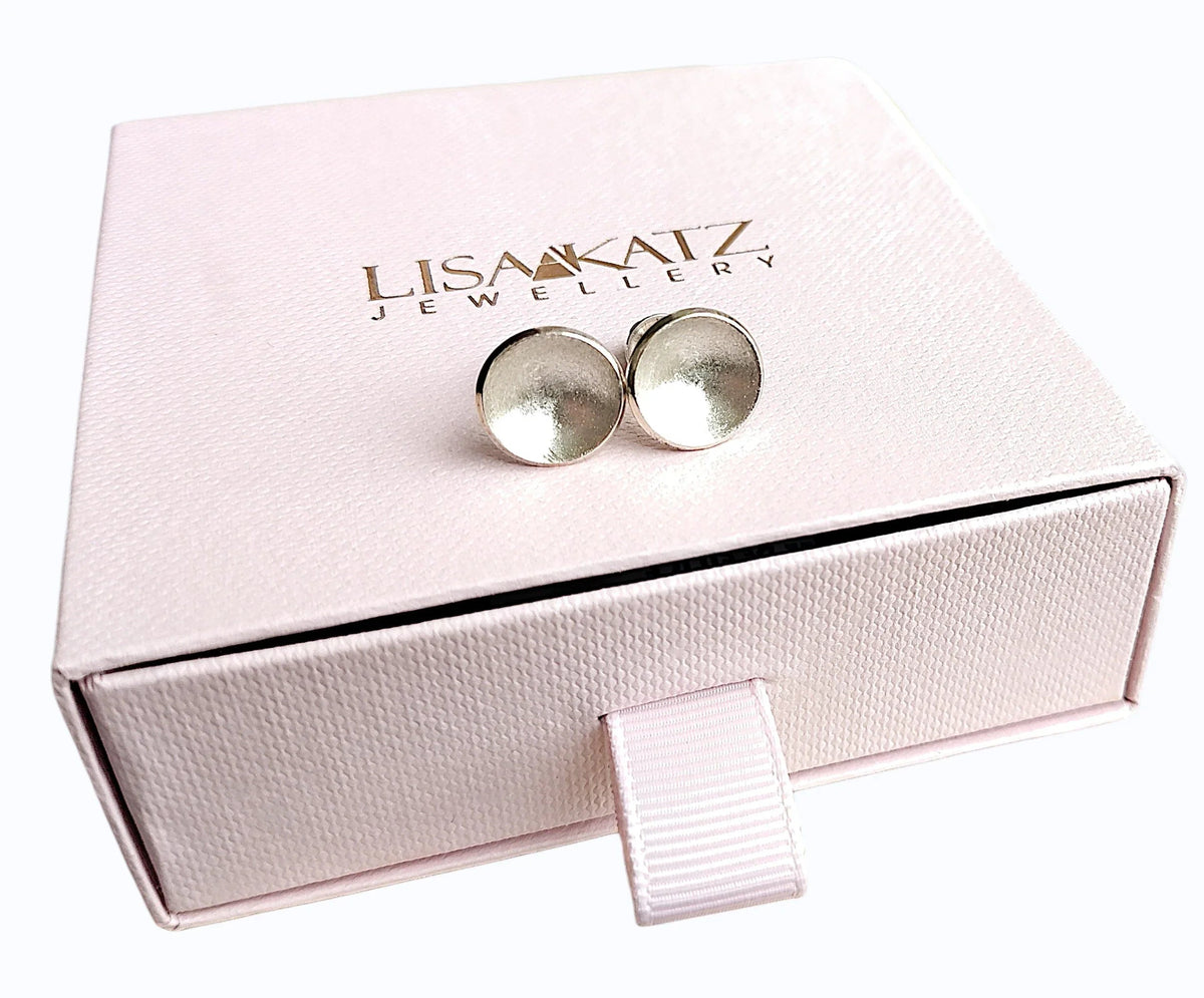 Silver dome stud earrings on a pink Lisa Katz Jewellery gift box.